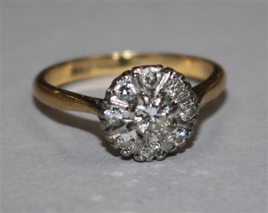 An 18ct gold and diamond cluster ring, size N.